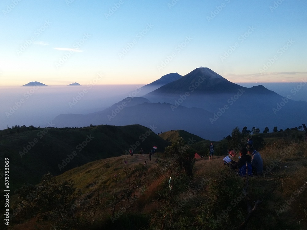 Obraz premium panorama of beautiful countryside of Indonesia. wonderful springtime landscape in mountains. grassy field and rolling hills. rural scenery