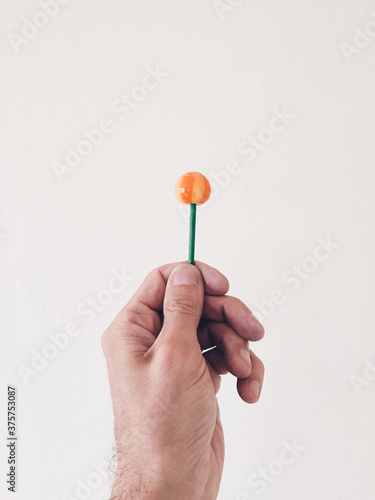 Hand holding lolly photo