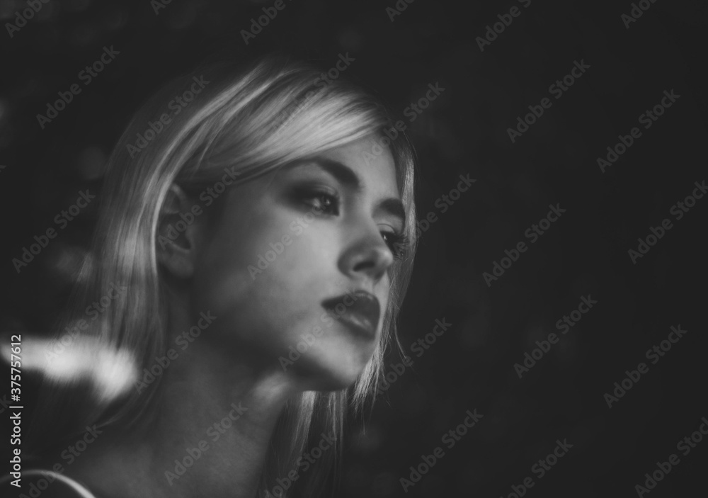 Portrait of a beautiful girl standing next to window and watching rain Portrait of a beautiful girl standing next to window and watching rain