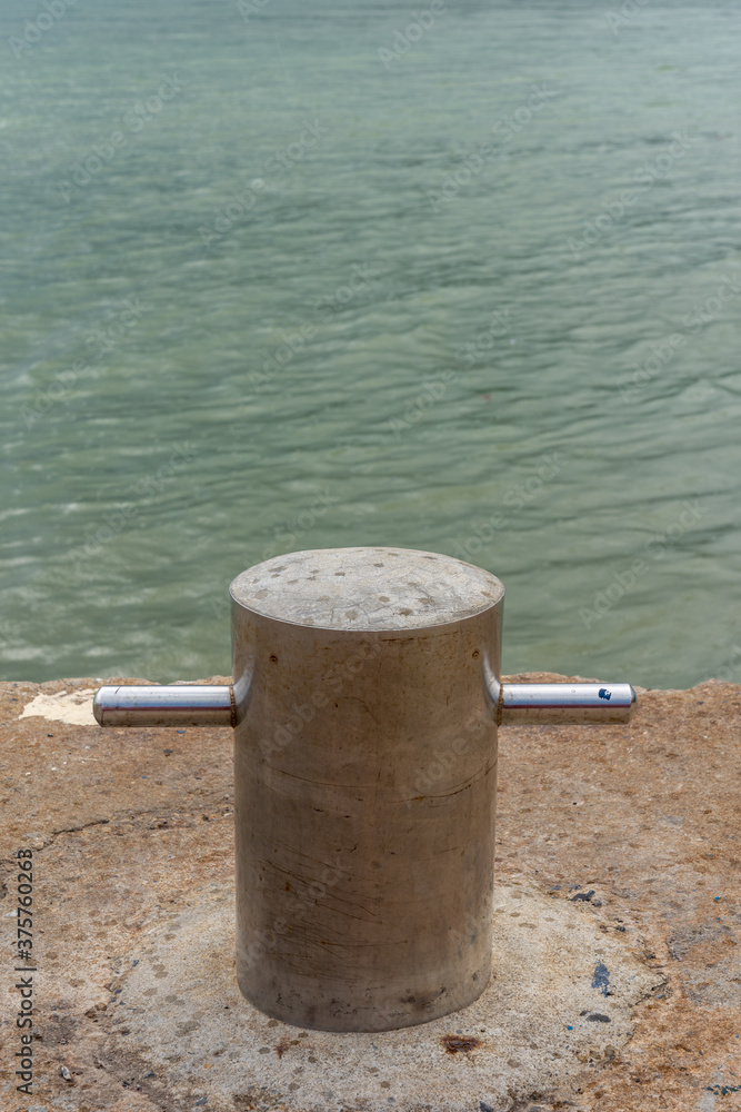 Docking pole to secure the boat, equipment at the harbor Docking pole to secure the boat, equipment at the harbor