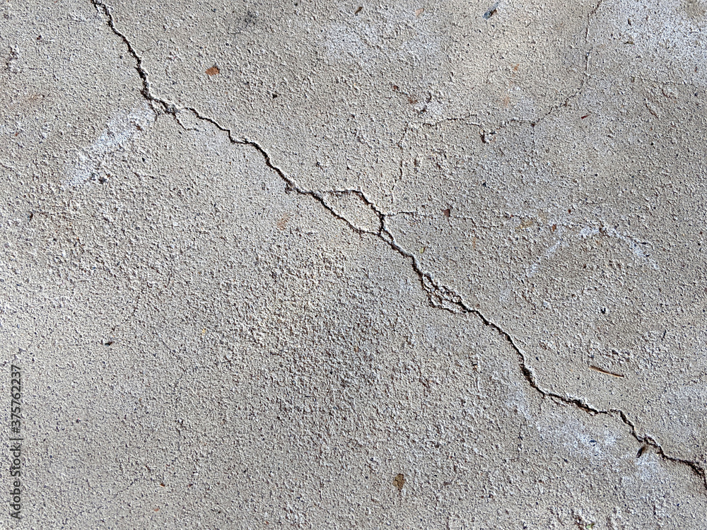 Obraz premium Large Crack Diagonal from Corner to Corner on Concrete Floor or Sidewalk, Damage on Concrete