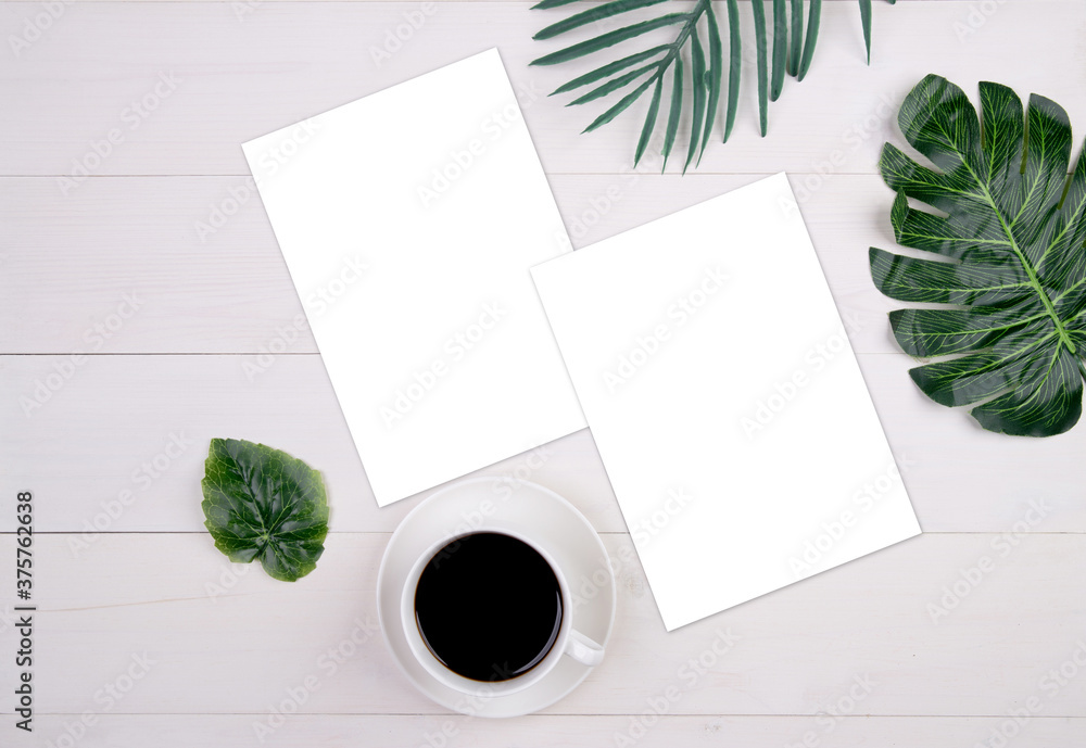 Blank paper sheet copy space with mockup and leaf and cup of coffee on wooden table, poster and invitation, postcard decoration your design or branding, nobody, flat lay, top view. Blank paper sheet copy space with mockup and leaf and cup of coffee on wooden table, poster and invitation, postcard decoration your design or branding, nobody, flat lay, top view.