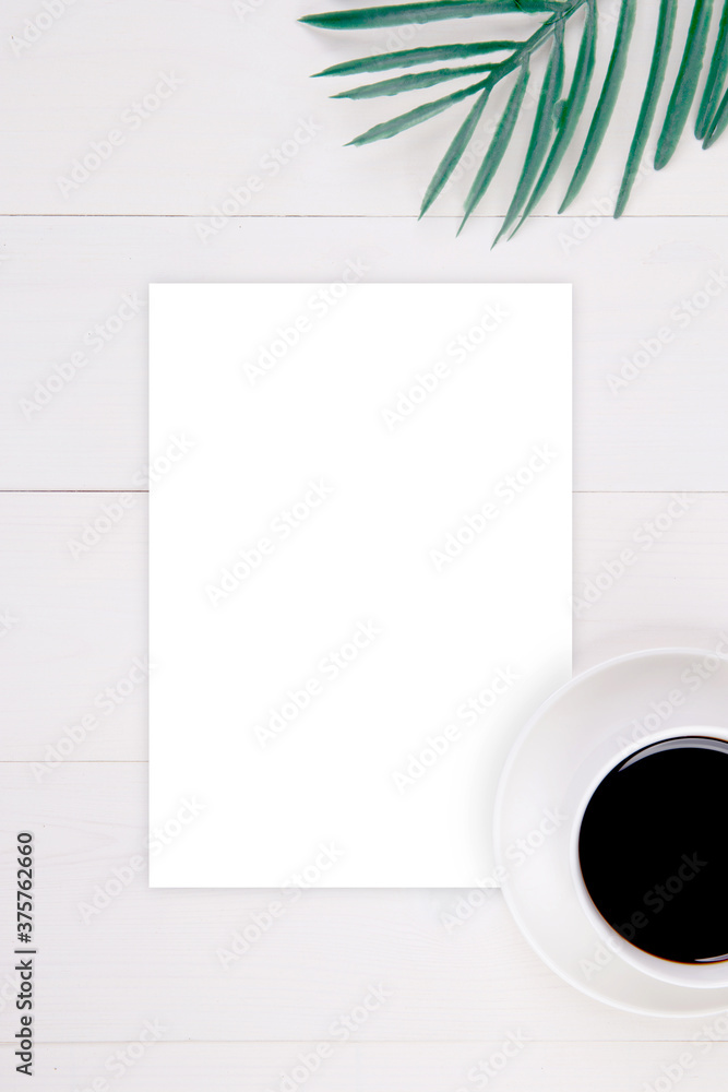 Blank paper sheet copy space with mockup and leaf and cup of coffee on wooden table, poster and invitation, postcard decoration your design or branding, nobody, flat lay, top view. Blank paper sheet copy space with mockup and leaf and cup of coffee on wooden table, poster and invitation, postcard decoration your design or branding, nobody, flat lay, top view.