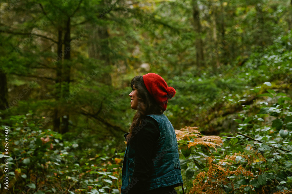 female looking into the woods female looking into the woods