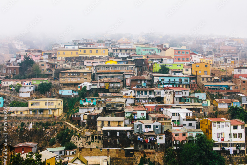 Slums cityscape view of colourful houses with mist in Valparaiso, Chile Slums cityscape view of colourful houses with mist in Valparaiso, Chile