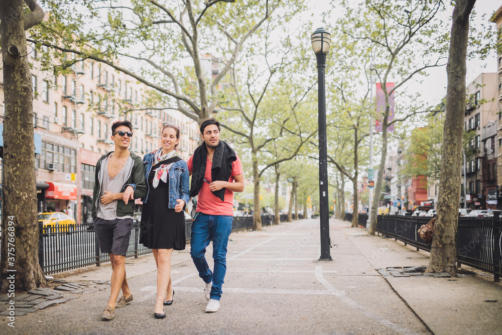 Three Friends in Casual Walking Leisurely in New York Lower East Side Three Friends in Casual Walking Leisurely in New York Lower East Side