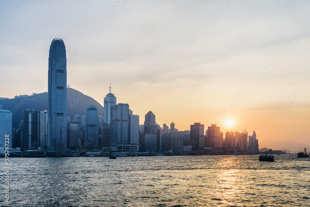 Victoria Harbor and skyscrapers in downtown at sunset, Hong Kong