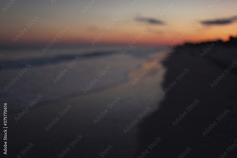 blurred view of the ocean at sunset blurred view of the ocean at sunset