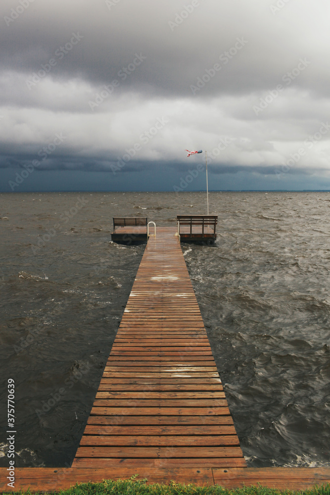 summer storm brewing across from a dock summer storm brewing across from a dock