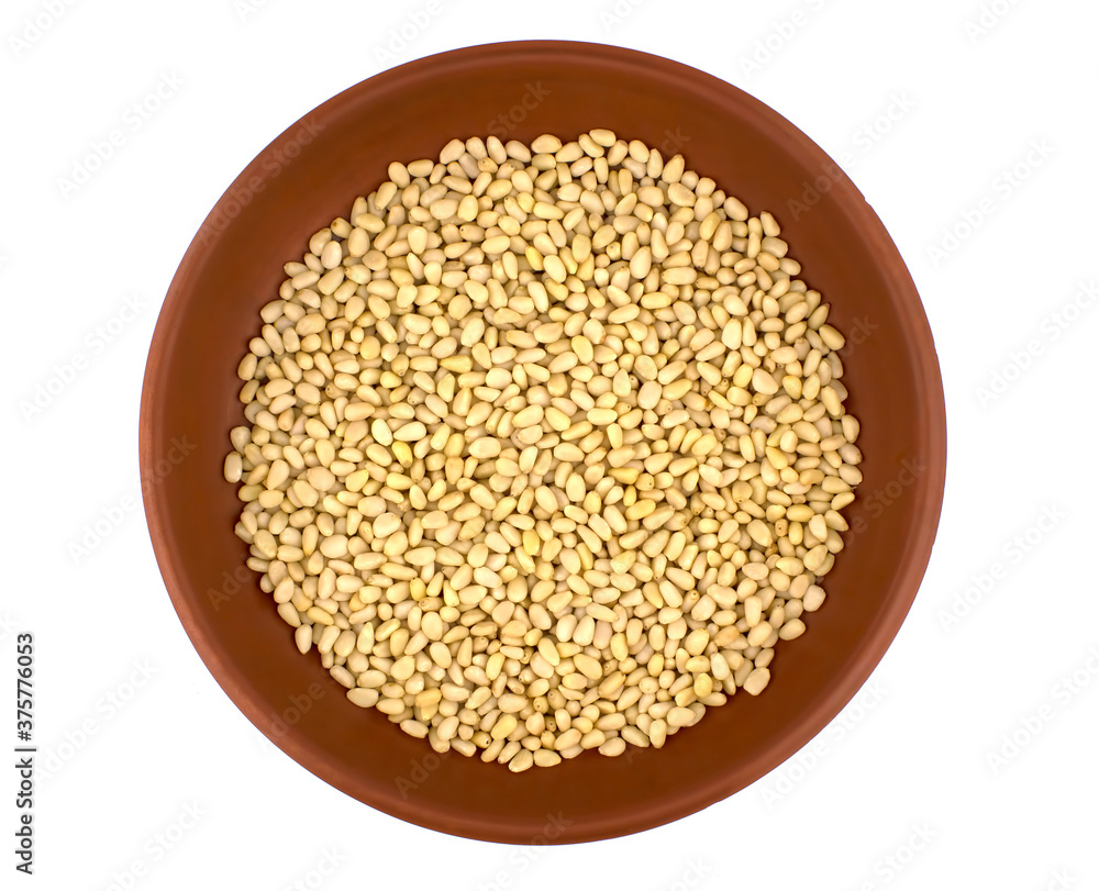 Bowl with pine nuts on white background Bowl with pine nuts on white background