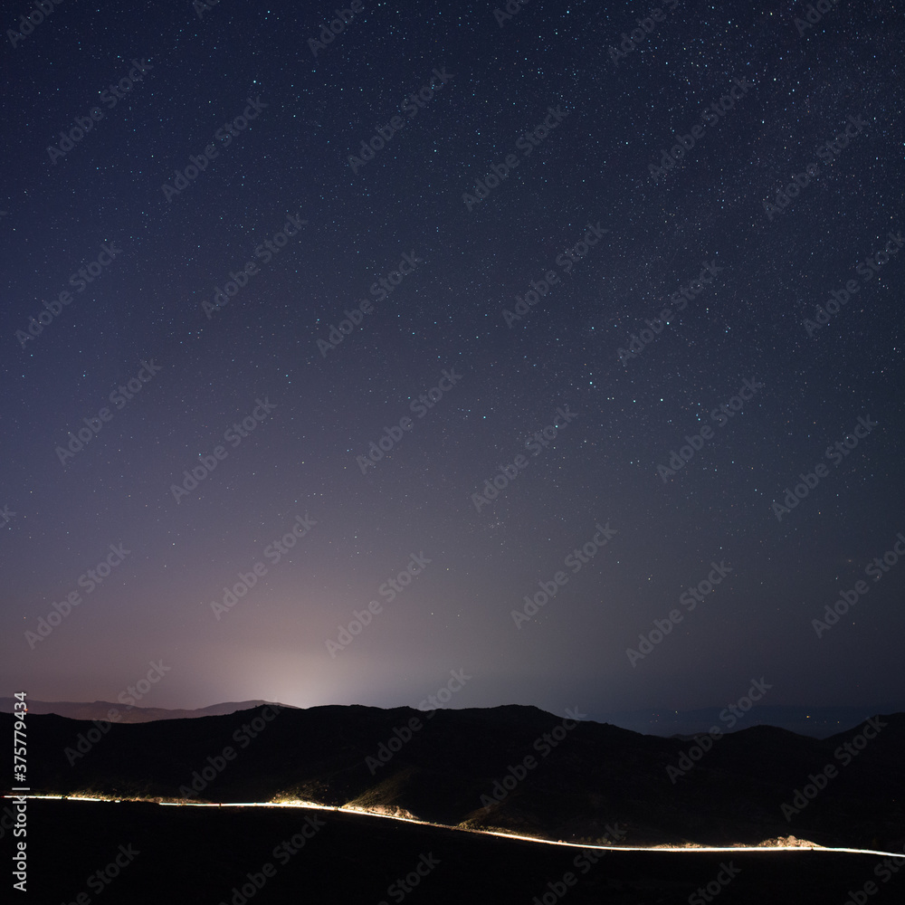Night sky and illuminated mountain road Night sky and illuminated mountain road
