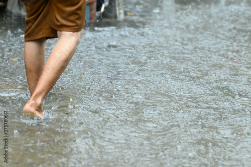 Fototapeta Naklejka Na Ścianę i Meble -  Legs walking through the flood