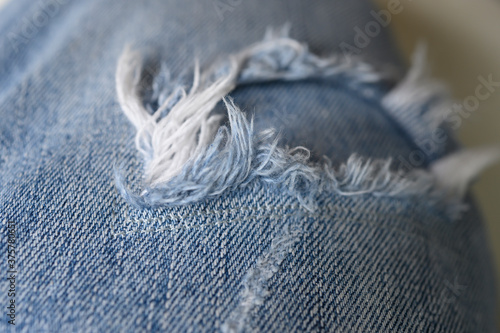 Blue jeans with holes and white threads