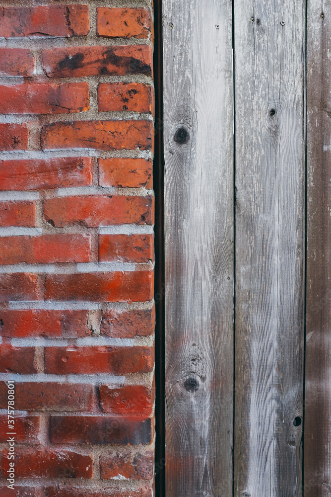 Detail of old brick wall and wood siding Detail of old brick wall and wood siding