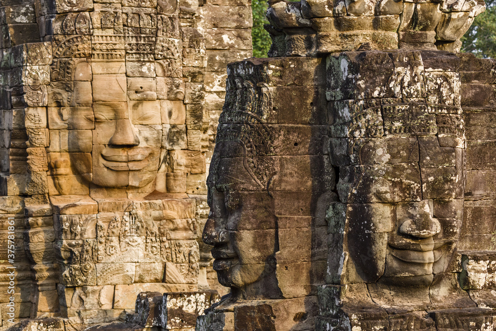 serene and smiling stone faces on towers of Bayon Temple, Angkor, Cambodia serene and smiling stone faces on towers of Bayon Temple, Angkor, Cambodia