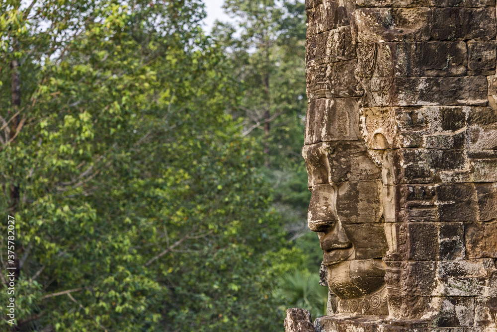 serene and smiling stone faces on towers of Bayon Temple, Angkor, Cambodia