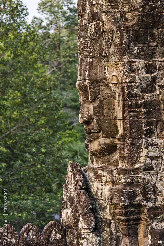 serene and smiling stone faces on towers of Bayon Temple, Angkor, Cambodia serene and smiling stone faces on towers of Bayon Temple, Angkor, Cambodia