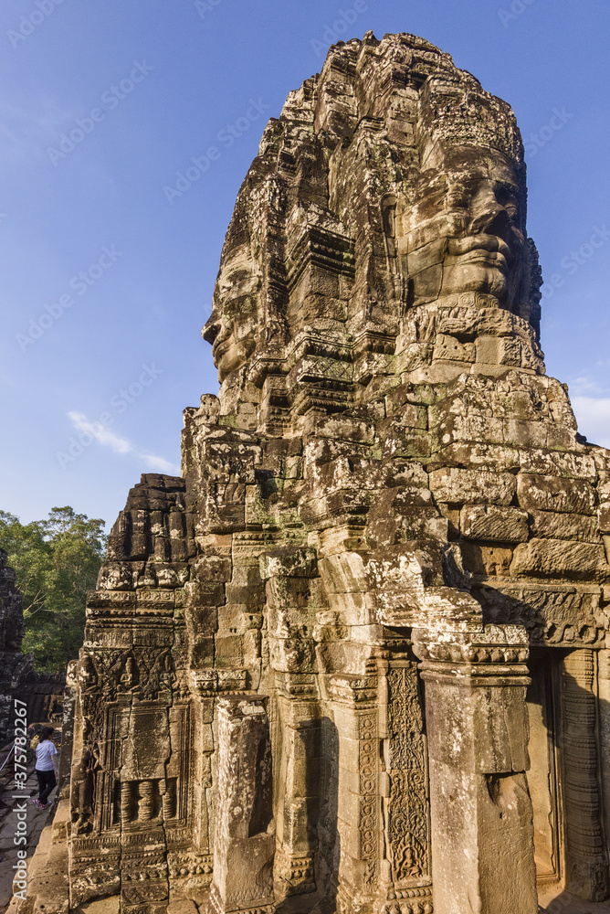 serene and smiling stone faces on towers of Bayon Temple, Angkor, Cambodia