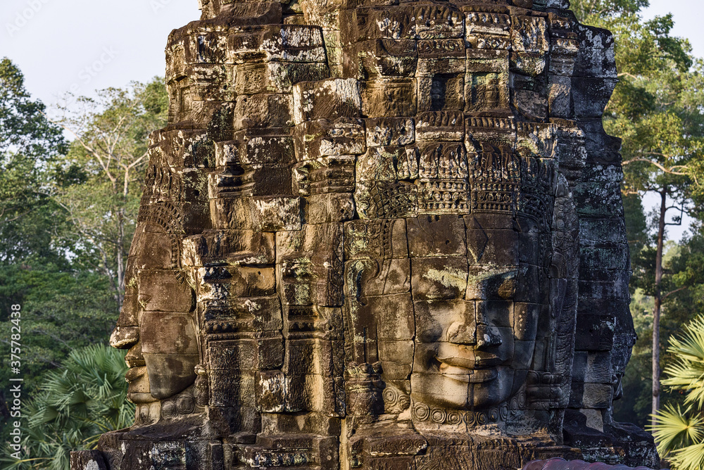 serene and smiling stone faces on towers of Bayon Temple, Angkor, Cambodia