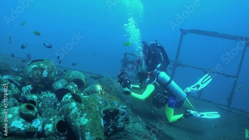 Wallpaper Mural Two divers take pictures on a sunken ship. Bali. Tulamben. Torontodigital.ca
