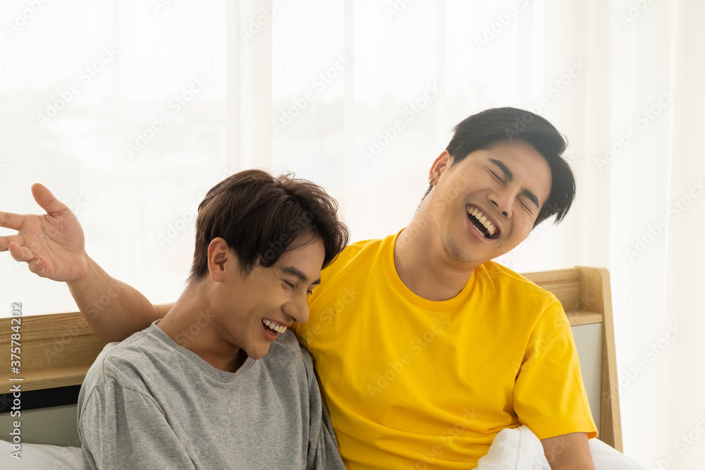 Asian gay homosexual couple hug and embracing on the bed.  Gender equality and right concept, playful and romantic moment.