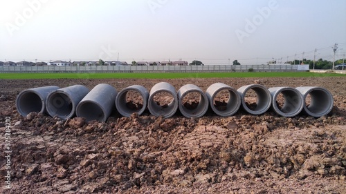 Concrete drainage pipes.Construction of main water supply pipeline. Laying underground storm sewers at construction site. Water main, sanitary sewer, drain systems. Utility Infrastructure