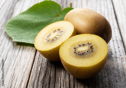 Golden kiwi on a wood grain background