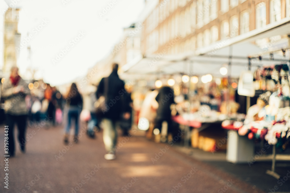 Anonymous blurred people walking down the market place. Anonymous blurred people walking down the market place.