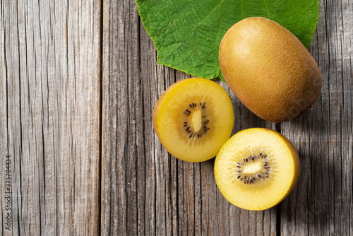 Golden kiwi on a wood grain background