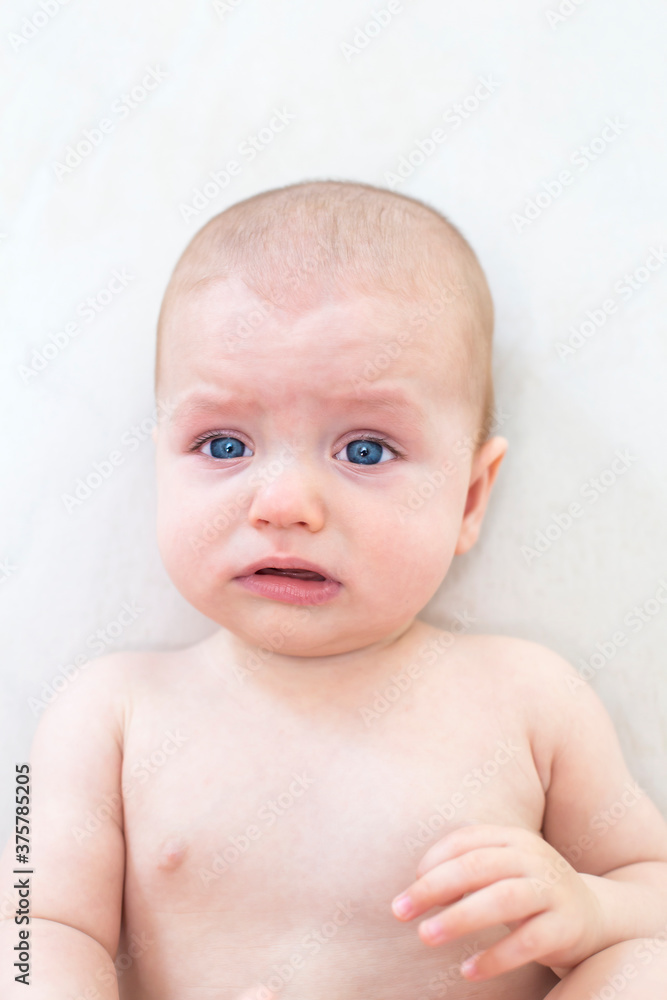 Cute baby girl lying on bed