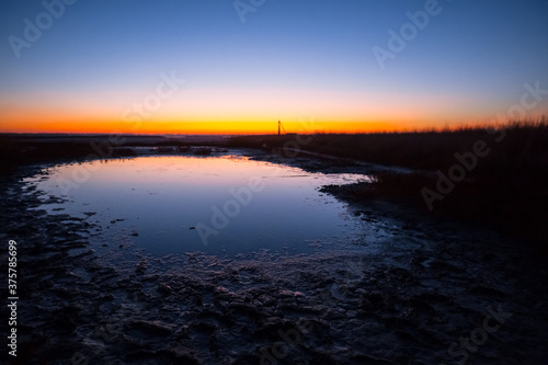 small lake in a prairie at the twilight  dramatic cuiet evening outdoor background