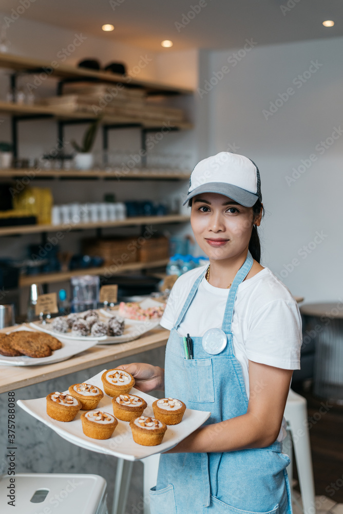 Waitress Holding A Plate With Cupcakes At The Restaurant Waitress Holding A Plate With Cupcakes At The Restaurant