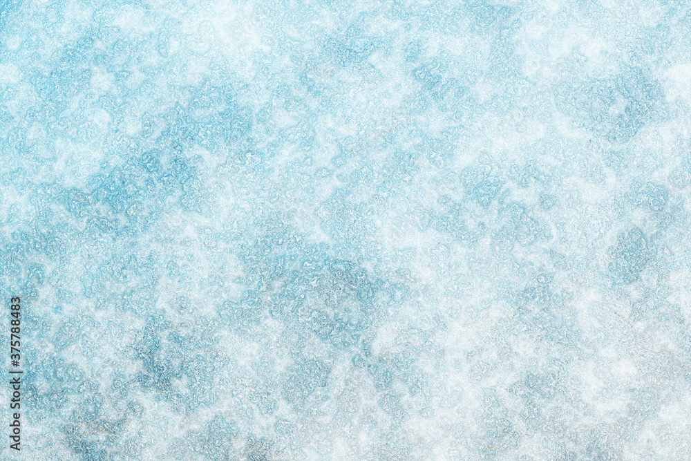 Obraz premium The surface of the earth is covered with snow. Frost texture iced surface - Winter material. Texture of ice. Snow texture. Cracked ice background. Abstract frozen water.Ice texture winter background.