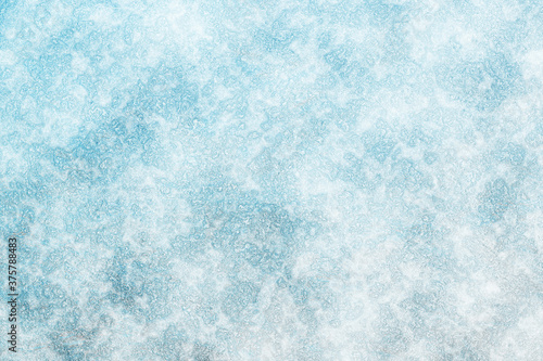 The surface of the earth is covered with snow. Frost texture iced surface - Winter material. Texture of ice. Snow texture. Cracked ice background. Abstract frozen water.Ice texture winter background.