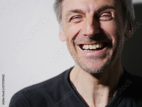 portrait middle-aged man laughing photo