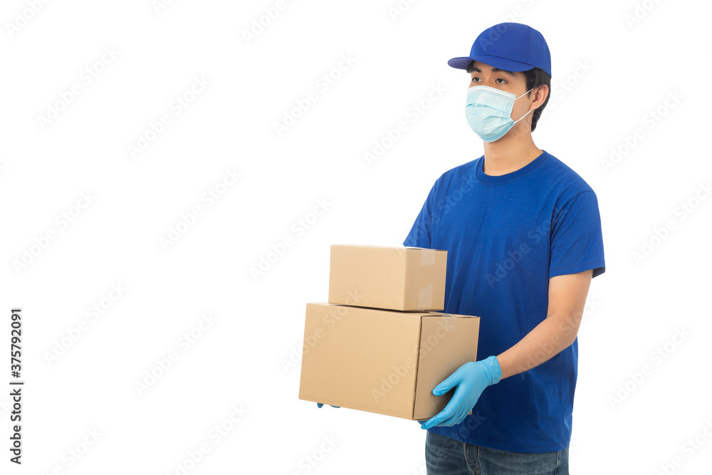 Young Delivery man wearing mask and medical gloves holding paper cardboard box mockup isolated on white background with clipping path. Young Delivery man wearing mask and medical gloves holding paper cardboard box mockup isolated on white background with clipping path.