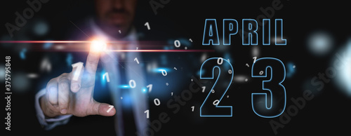 april 23rd. Day 23 of month,advertising or high-tech calendar, man in suit presses bright virtual button spring month, day of the year concept