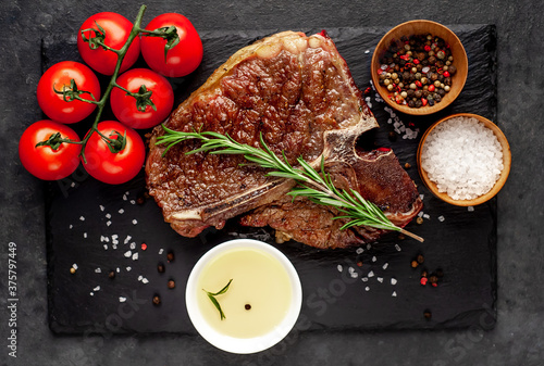 Quadro em tela grill t-bone steak with ingredients on stone background