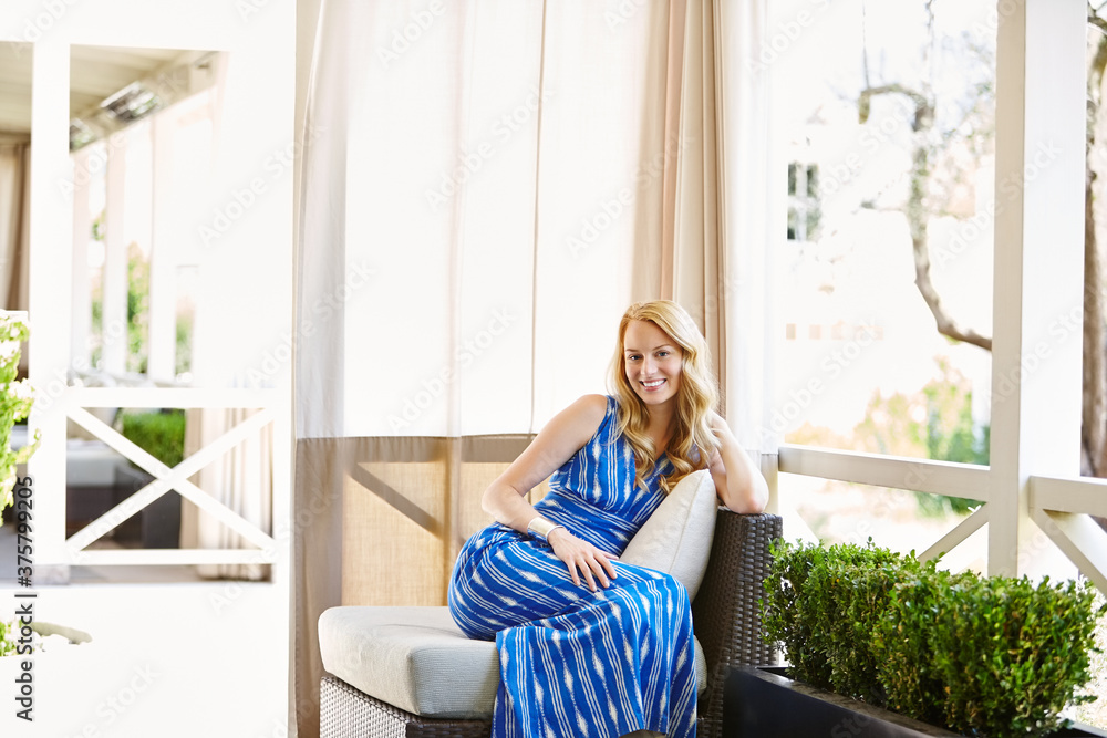 Beautiful woman in blue dress relaxing at resort Beautiful woman in blue dress relaxing at resort