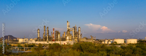 Oil refinery plant from industry zone  Aerial view oil and gas petrochemical industrial  Refinery factory oil storage tank and pipeline steel at night  Ecosystem and healthy environment concepts.