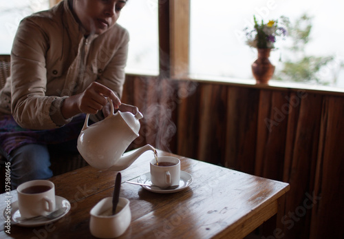 Woman pouring tea photo