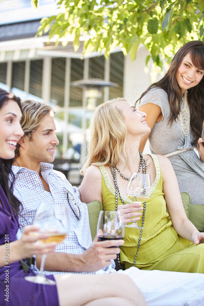Group of friends enjoying drinks at outdoor lounge Group of friends enjoying drinks at outdoor lounge