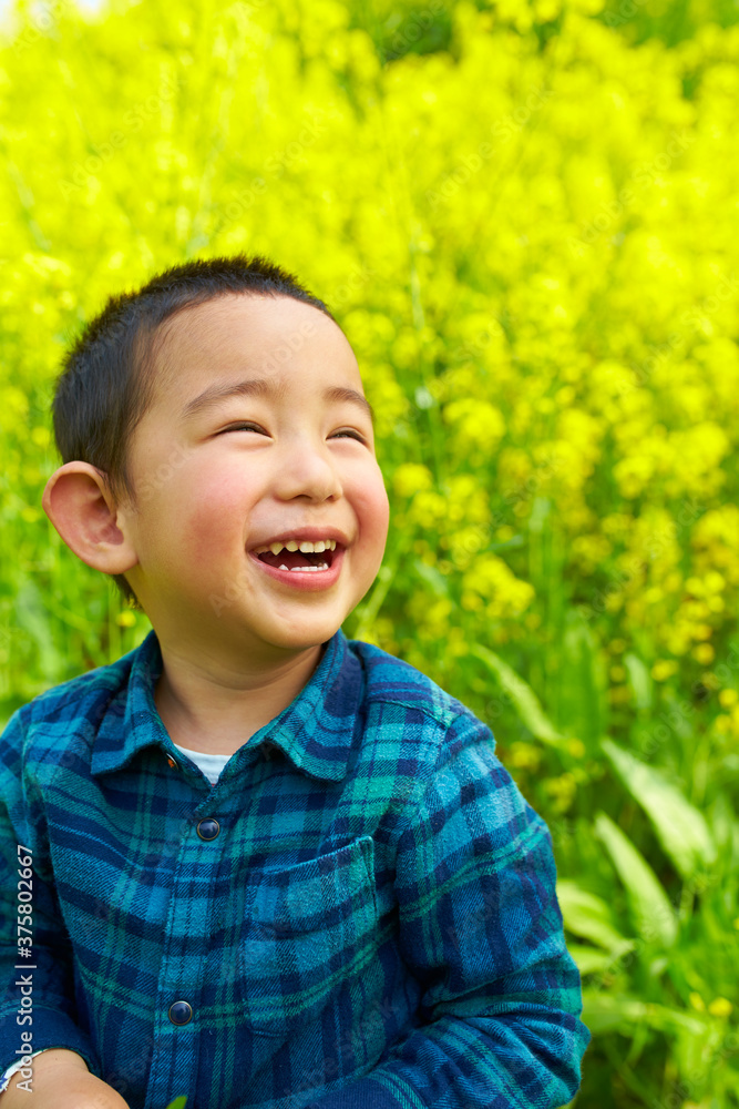 happy little Chinese kid playing in spring field happy little Chinese kid playing in spring field