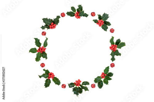 Christmas, winter & New Year holly berry wreath decoration with red bells on white background. Flat lay top view, copy space. Design element.