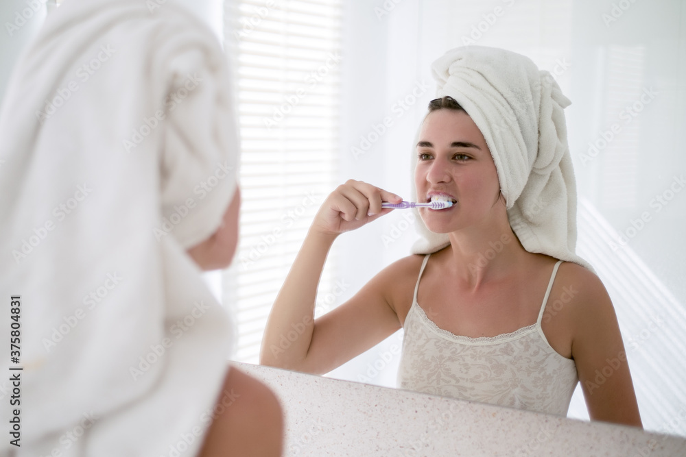 Woman Looking Herself In The Mirror and Brushing Her Teeth Woman Looking Herself In The Mirror and Brushing Her Teeth