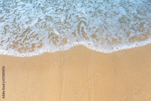 White wave on fine sand beach, nature concept background, clean environment
