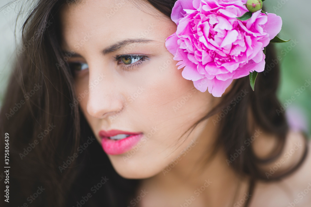 Portrait of a young woman with peony in her hair Portrait of a young woman with peony in her hair