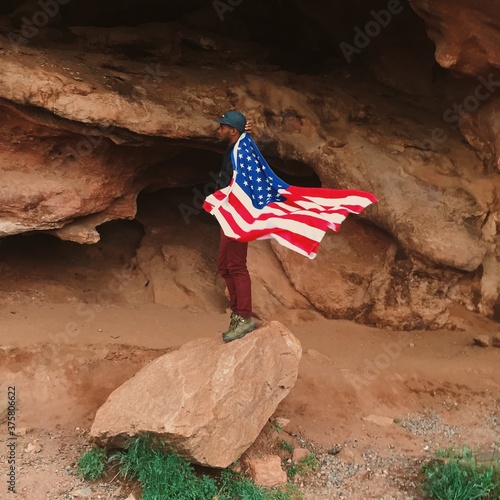 Mobile phone shot of a man holding an American flag photo