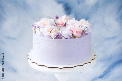 Beautiful cakes. Cake with pink rose flowers, purple  meringues on wooden stand. Wedding cake, birthday cake, Mother's day, 8 march, womens day, cake with roses and lavender