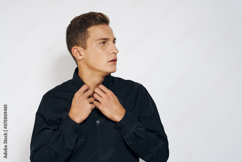 Man in black shirt lifestyle emotions modern style cropped view light background Man in black shirt lifestyle emotions modern style cropped view light background